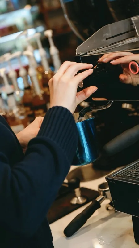 Barista operating the espresso machine